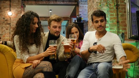WROCLAW, POLAND - SEP 22, 2020: After party friends guys young people drink alcohol beer having fun hanging out together in a bar