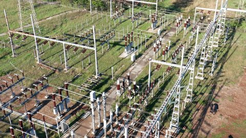 Electrical substation - grid of high voltage power lines and wires. Long-range energy transmission. Aerial view.