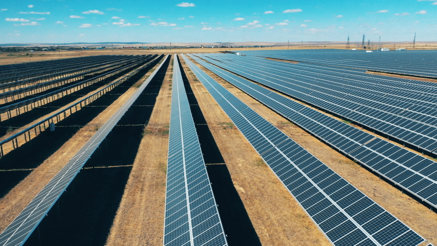 Side view of solar power panels in lines. Solar power, solar panel, solar farm concept. | Shutterstock HD Video #1061050564