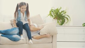 4k slowmotion video where girl is sitting on his sleepy father.
