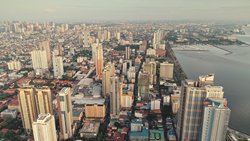 Manila pier town cityscape at ocean bay aerial. Amazing architecture attraction and modern buildings. Streets at roads with green trees. Cinematic Philippines metropolis scenery at summer day Royalty-Free Stock Footage #1061055373