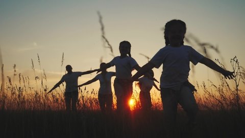 dream future concept. children kid run happy family concept at sunset silhouette. hands on hand play aviator pilot show airplane. people in the park parents mom and dad children daughter play