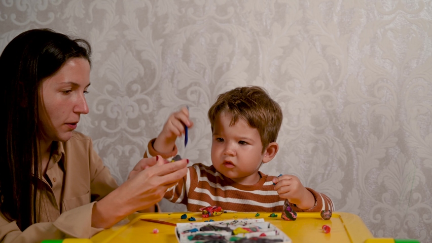 Child with mother play plasticine. Fun educational games. | Shutterstock HD Video #1061061910