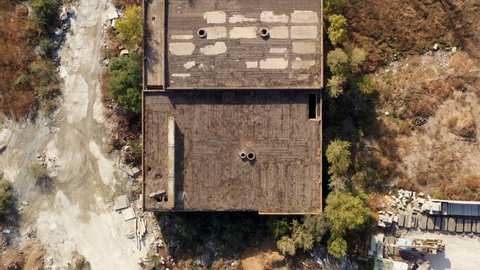 Aerial view of damaged and abandoned house in rural area. Abandoned and destroyed house.