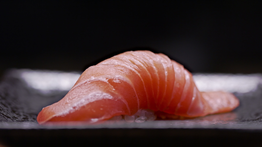 Medium Tuna brushed to perfection. Authentic Japanese sushi is prepared by an expert chef. Shot in 4k.  Royalty-Free Stock Footage #1061065399