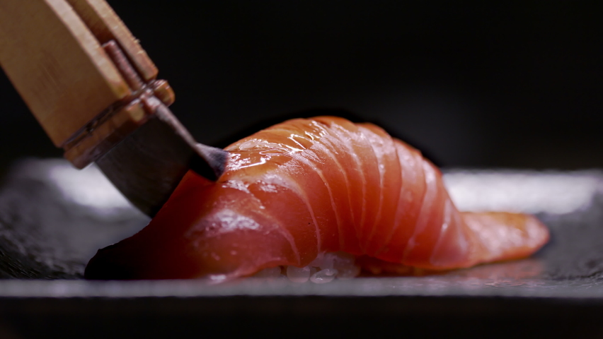 Medium Tuna brushed to perfection. Authentic Japanese sushi is prepared by an expert chef. Shot in 4k.  | Shutterstock HD Video #1061065399