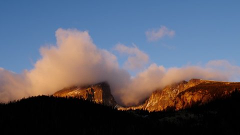 Time Lapse of the clouds moving above the rugged mountains in the Rocky Mountains National Park in Colorado USA.