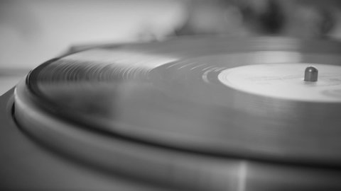 Black and White. The vinyl record spins without a needle. Old turntable.