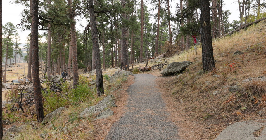 Devils Tower Wyoming woman hiking mountain trail 4K. 1,267 feet tall igneous rock tower in Black Hills of South Dakota and Wyoming. United States National Monument. Recreation, tourism.