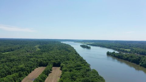 Flying over beautiful farmland and trees with the Potomac river cutting through the middle drone aerial