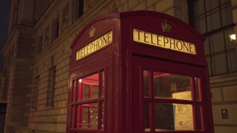 close view of typical beautiful unique london red telephone cabin at night time
