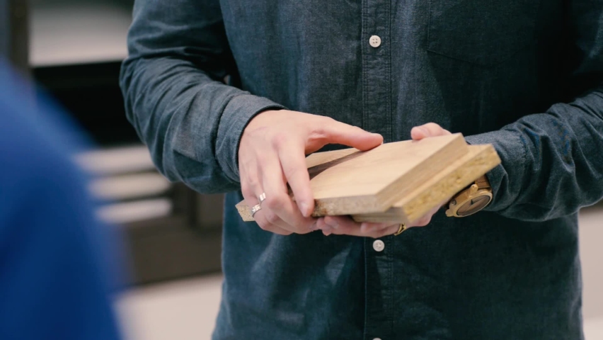 Samples of chipboard board cut parts for the production of furniture in the hands of a sales consultant | Shutterstock HD Video #1061075779