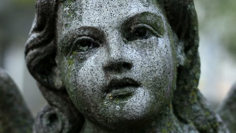 Cemetery statue of a girl slow camera movement 