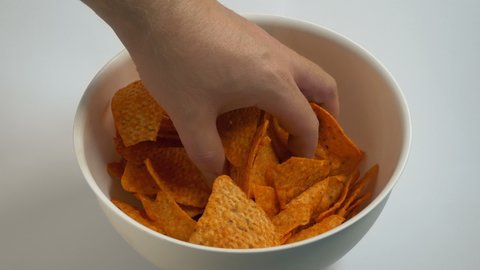 Man Grabs Handfuls Of Chips From Bowl