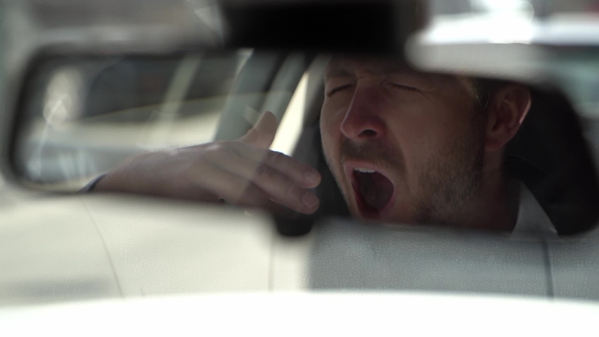 Man yawn in his car because is so tired | Shutterstock HD Video #1061088418