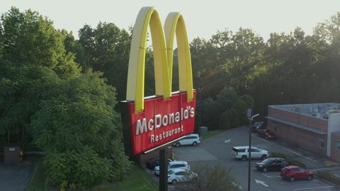 Pittsburgh , Pennsylvania / United States - 09 23 2020: Drone aerial orbit of McDonald's Golden Arches sign fast food restaurant