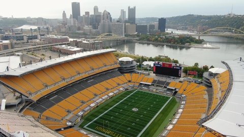 Pittsburgh , PA / United States - 10 10 2020: Heinz Field, stadium of Pittsburgh Steelers NFL team. Urban city skyline in distance with Allegheny and Monongahela River. Aerial dolly shot.