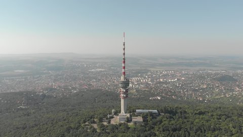 Orbiting drone footage of the Pécs TV Tower. Pécs is the fifth largest city of Hungary, on the slopes of the Mecsek mountains, administrative and economic center of Baranya County