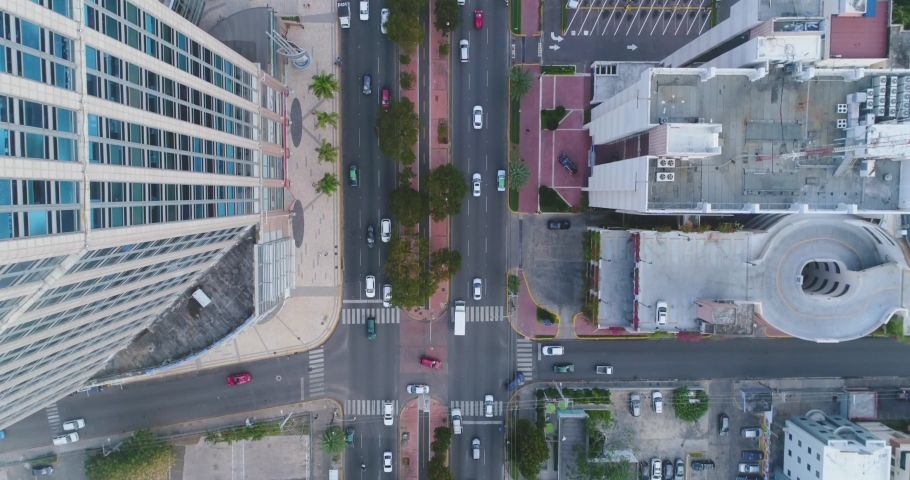 Birdseye view of cars moving through busy city streets in Santo Domingo Dominican Republic drone aerial Royalty-Free Stock Footage #1061095336
