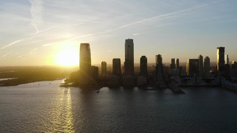 Jersey City sunset. A flyby on the Hudson River during sunset looking west. Jersey City is booming and growing with residents looking for a place near NYC.