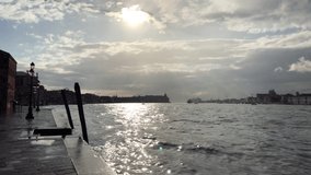Sun shines after storm in beautiful Venetian lagoon filmed in spring season.Popular travel destination in Metropolitan City of Venice in Italy.Royalty free 4K videoclip filmed in beautiful Venezia