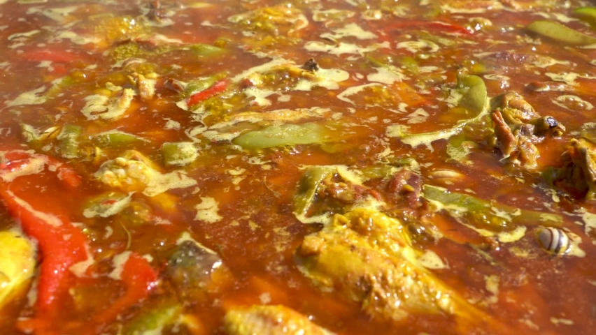 Valencian paella boiling before throwing the rice Royalty-Free Stock Footage #1061108644