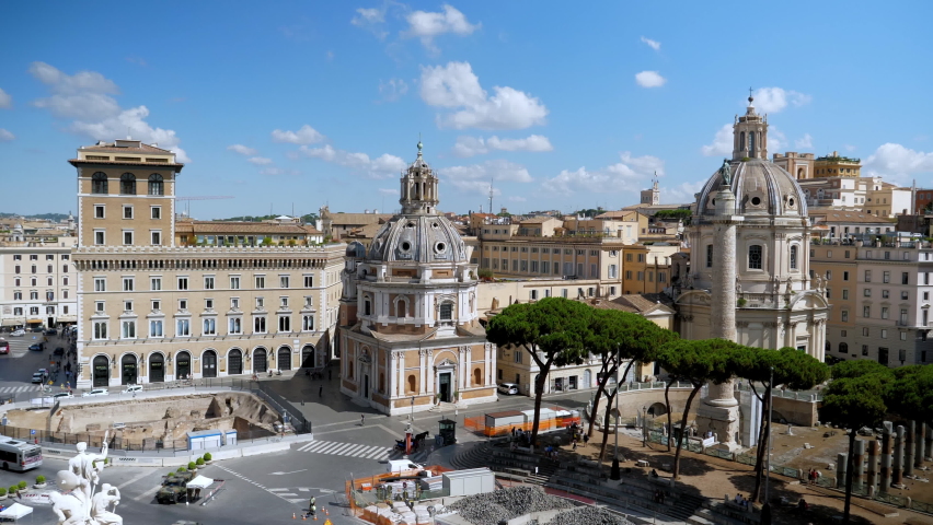 ROME,ITALY-SEPTEMBER,10,2020:The front view on the column of Emperor Trajan in the middle of th square, the remains of the ancient Forum and the two churches located near Piazza Venezia in a sunny day