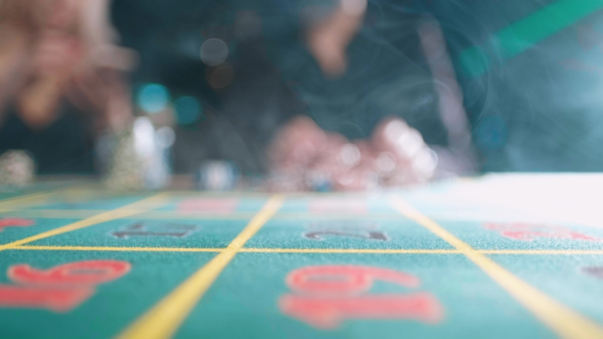 Risky man betting all chips in while playing in casino. Royalty-Free Stock Footage #1061112910