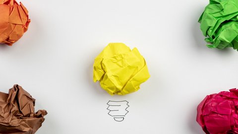 Conceptual video. Inspiration and creative idea concept. Stop motion. Glowing paper light bulb.