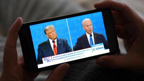 Los Angeles - 22 October 2020: Man Watching Trump vs Biden Presidential Debate on a Smartphone