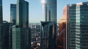 Moscow city glass skyscrapers drone zoom in close to the buildings. Famous Moscow International Business Center sunny evening time, blue horizon line on the background - Powered by Shutterstock - Get 15% off with code: PIKWIZARD15