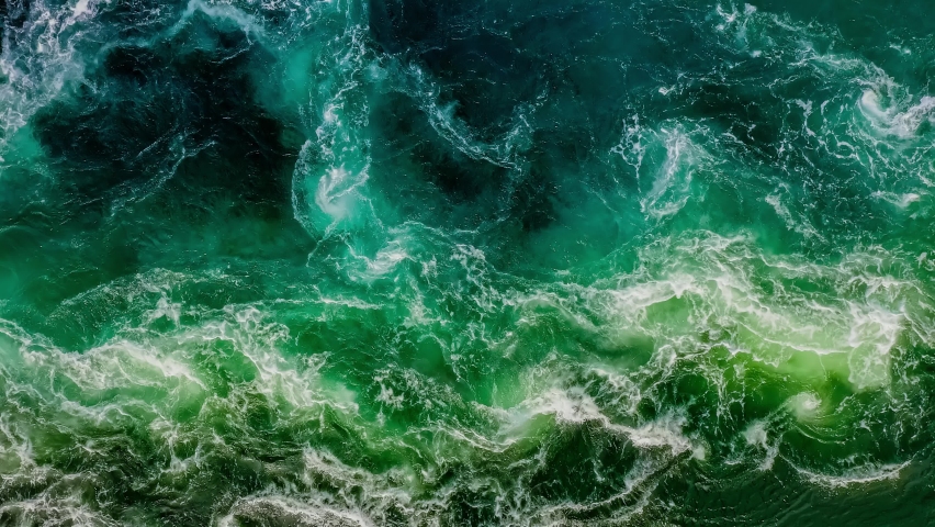 Waves of water of the river and the sea meet each other during high tide and low tide. Whirlpools of the maelstrom of Saltstraumen, Nordland, Norway Royalty-Free Stock Footage #1061128366