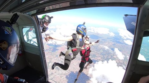 October 20, 2020. São Paulo, SP, Brazil. A team of parachutists jump out of an airplane, shot in super slow motion.