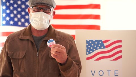 US elections 2020 concept. American retired masked to vote in 2020 US elections. Voting during the Coroanvirus Covid-19 pandemic