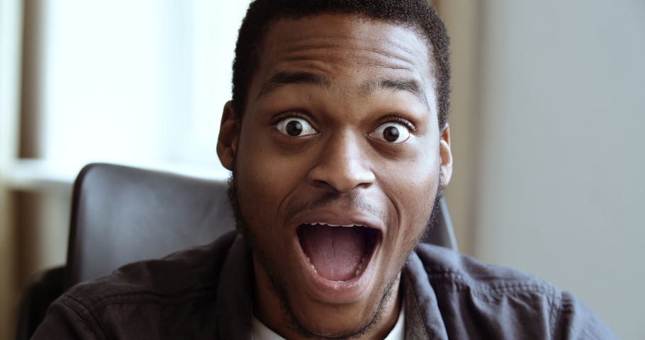 Portrait of amazed african american business man student shocked, saying WOW. Handsome black guy surprised to camera, opens his mouth with delight, emotions of happiness triumph on male face close-up | Shutterstock HD Video #1061132650