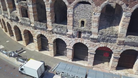 Aerial panoramic view of Arena di Verona, Italy. The drone flies near the wall and arches of the Arena. A view of the Arena and the city opens. 4k vieo.