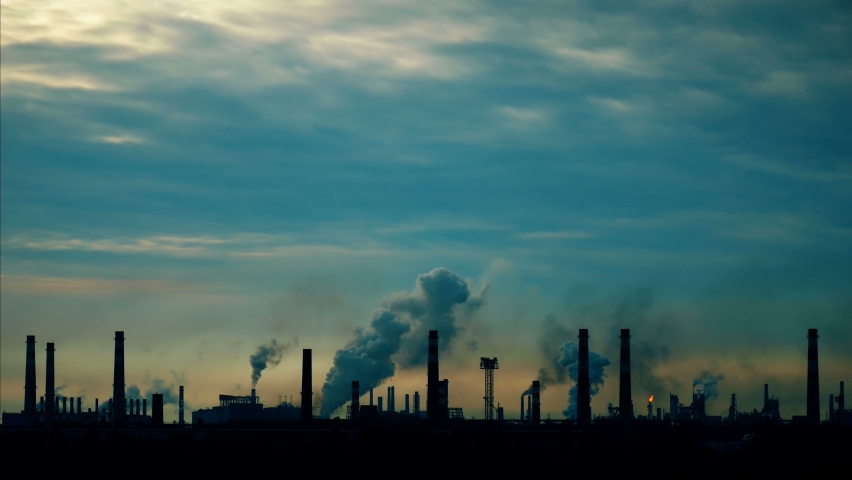 Industrial chimneys time lapse. Metallurgy blue sky. Metallurgical industrial factory. Poisoned air. Epic pollution of nature. Toxic substances.