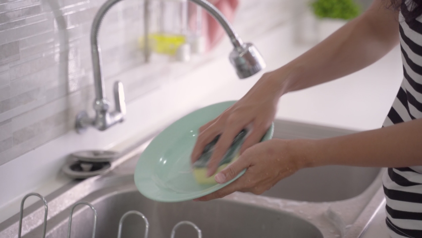 Close up of hand doing dish washing in the modern kitchen sink | Shutterstock HD Video #1061139925