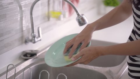close up of hand doing dish washing in the modern kitchen sink