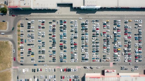 Time-lapse shooting, car parking of a shopping mall, top-down view.