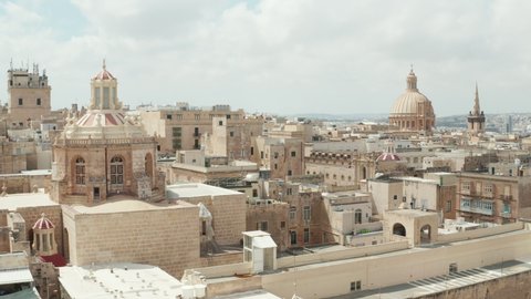 Aerial Establishing Wide Shot of Valletta City, Capital of Malta Island in Beige Color with beautiful Rooftops Scenic Cityscape at Daylight, Drone perspective