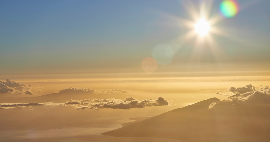 Time Elapse of setting sun above moving clouds above the Valley and ocean at the island of Maui from the top of the Haleakala Vocanic Crater,Haleakala National Park, Maui, Hawaii,USA