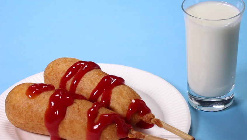 Homemade corn dogs and glass of milk Royalty-Free Stock Footage #1061152258