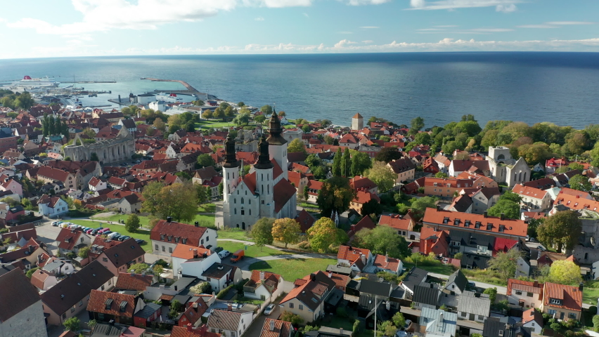 Visby, Gotland. Aerial drone footage flying over the town on the Swedish island located in the Baltic Sea. Medieval Town with city wall. Popular tourist destination in Sweden. | Shutterstock HD Video #1061154166