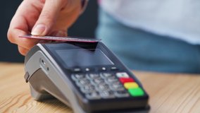 NFC credit card payment. Woman paying with contactless credit card with NFC technology. Wireless money transaction. Wireless payment - Powered by Shutterstock - Get 15% off with code: PIKWIZARD15