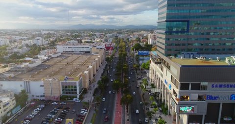 REP.DOM , SANTO DOMINGO / Dominican Republic - 03 26 2017: Drone flies over a busy city street filled with cars in urban Santo Domingo during Rush hour, Aerial Dominican Republic