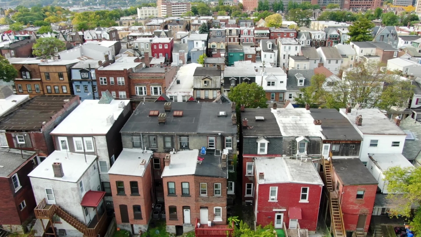 Colorful rowhomes in urban American city. Rundown low income housing in USA. Aerial truck shot. | Shutterstock HD Video #1061157244
