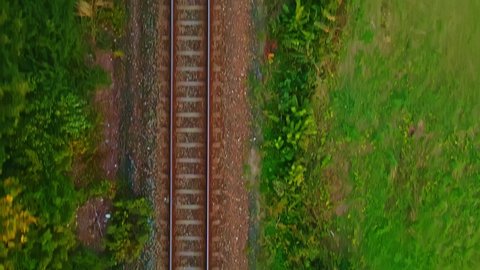 Moving along railroad tracks. Straight down point of view with motion blur 4K video.