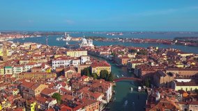 Aerial drone video of iconic and unique Grand Canal crossing city of Venice as seen from high altitude, Italy.