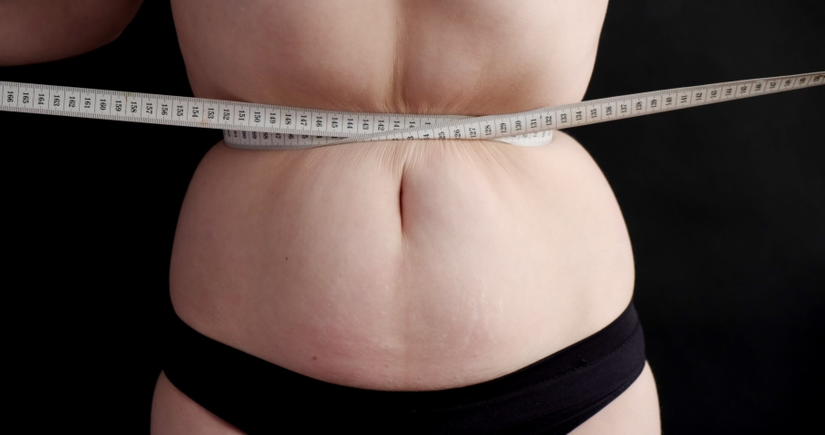 Excess weight woman, obesity problems. Fat female looking at her body, insecurities, examining stretch marks, dieting, needs healthy weight loss diet. Health Problems, Fat, Unhealthy | Shutterstock HD Video #1061164975